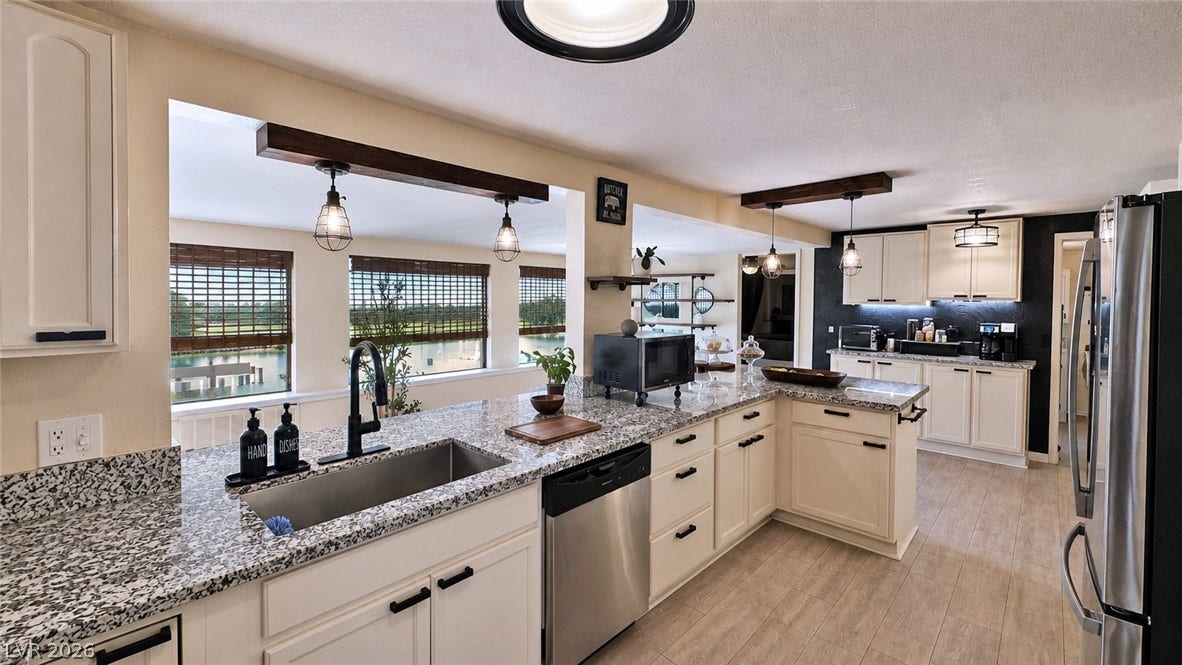 6130 Hawkins Way, Pahrump, NV 89061 Granite counters and light cabinetry define this spacious, modern kitchen with water views.