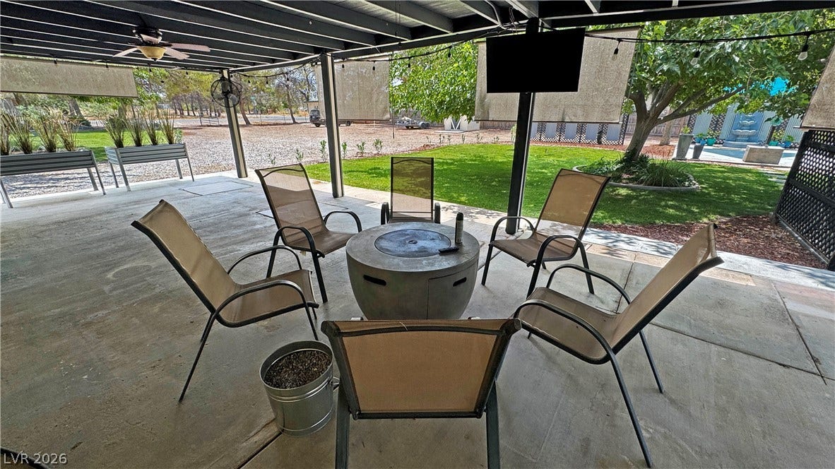 6130 Hawkins Way, Pahrump, NV 89061 A spacious covered patio provides a shaded concrete foundation overlooking the lush green yard.