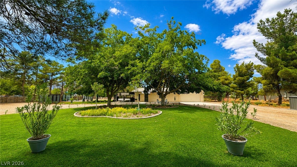 6130 Hawkins Way, Pahrump, NV 89061 Mature trees shade a manicured lawn framing the approach to this inviting property.