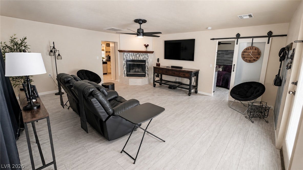 6130 Hawkins Way, Pahrump, NV 89061 An inviting fireplace and modern flooring anchors this comfortable living area.