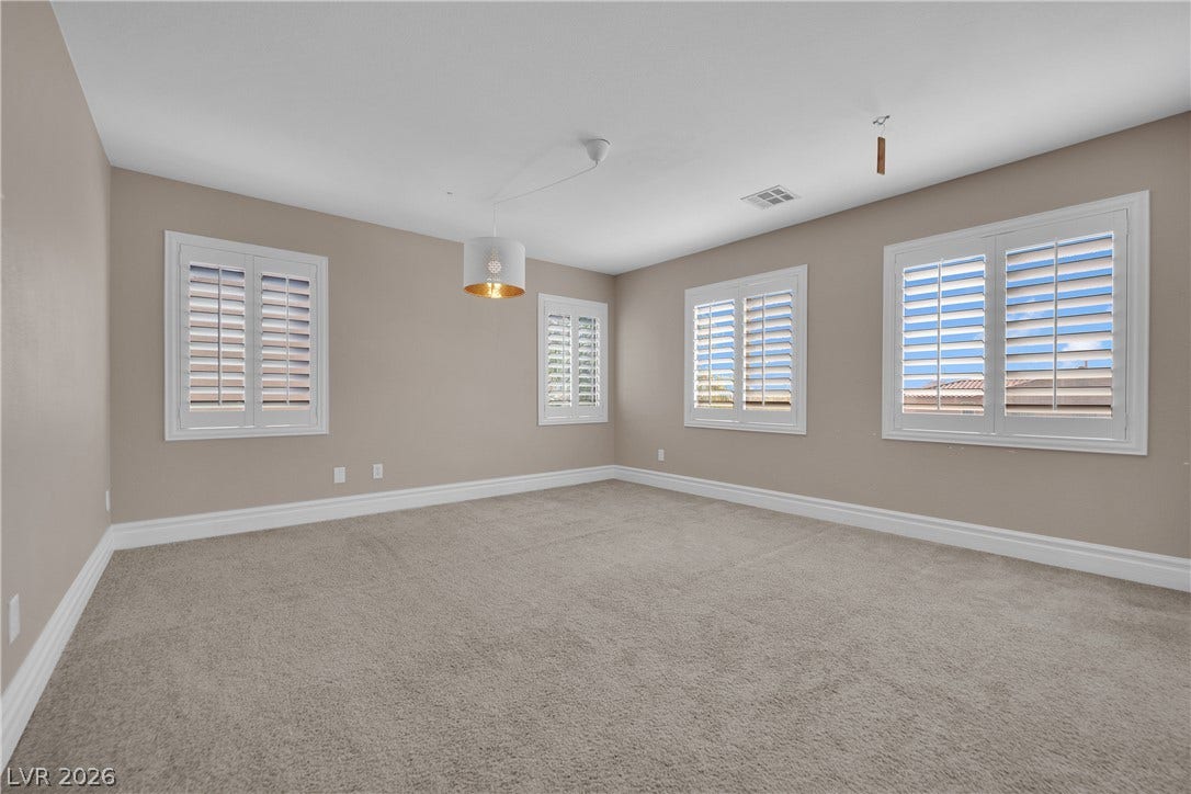 10149 Whitney Falls Court, Las Vegas, NV 89148 Crisp plantation shutters and plush carpeting define this versatile interior space.