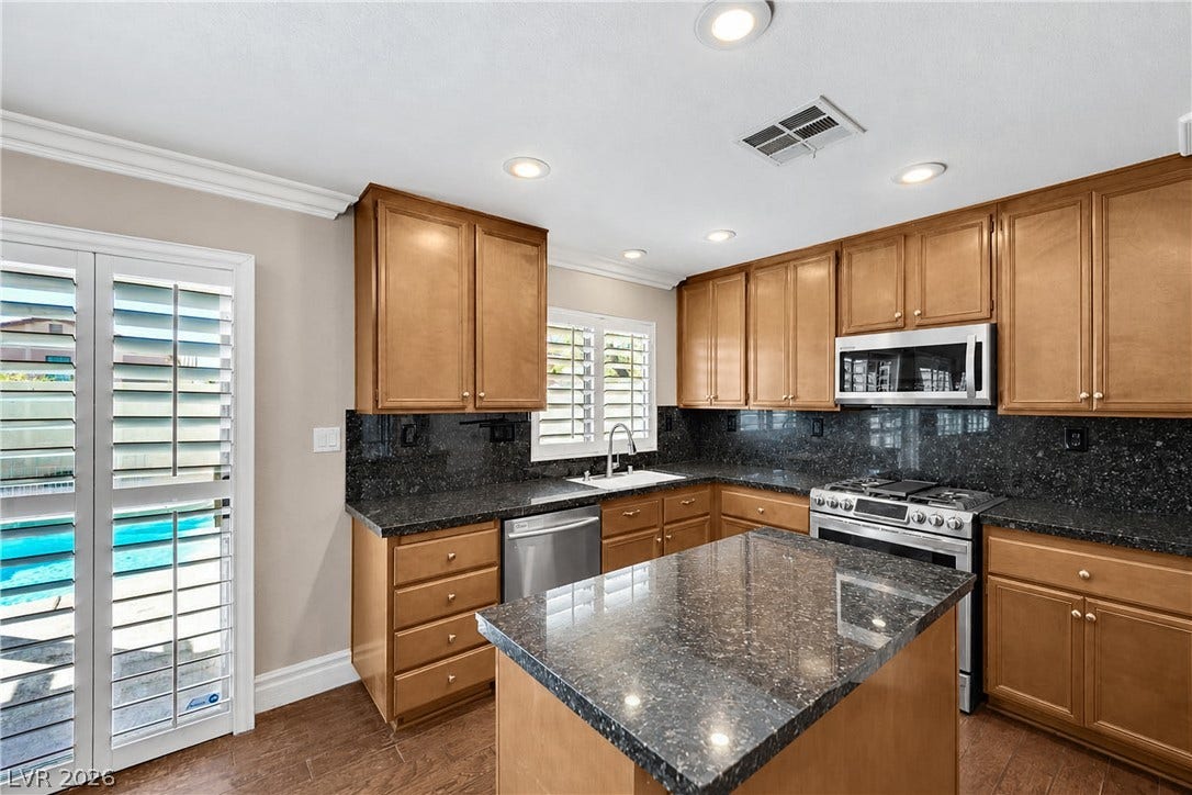 10149 Whitney Falls Court, Las Vegas, NV 89148 Gleaming stone countertops and a central island ground this classic culinary space.