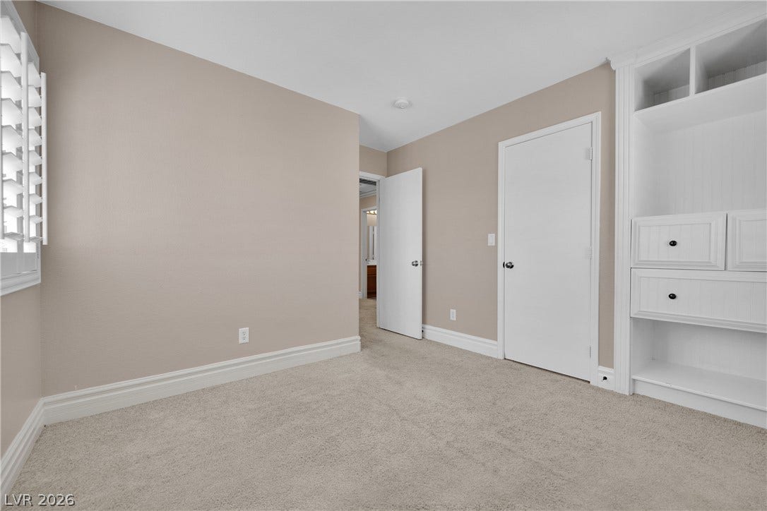10149 Whitney Falls Court, Las Vegas, NV 89148 Plush carpeting and custom built-in cabinetry define this versatile secondary bedroom space.