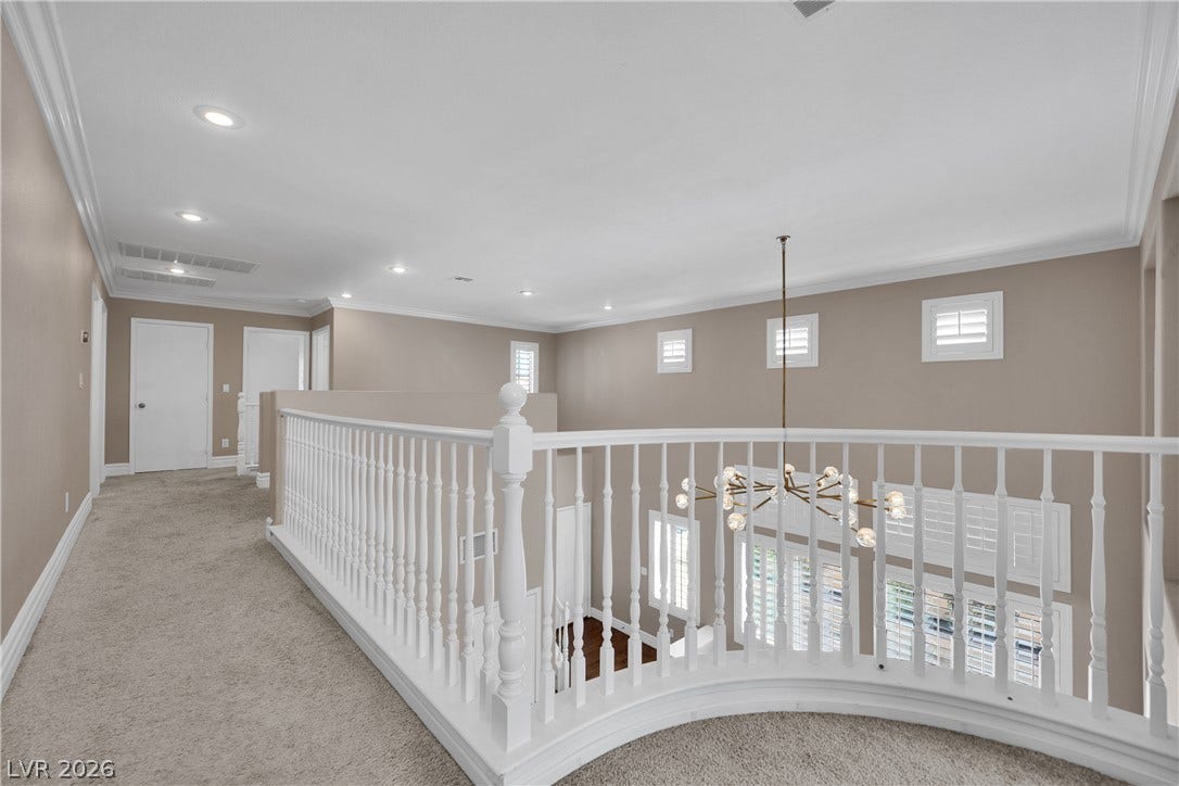 10149 Whitney Falls Court, Las Vegas, NV 89148 A spacious upper-level landing features plush carpeting and a curved banister overlooking the lower level.