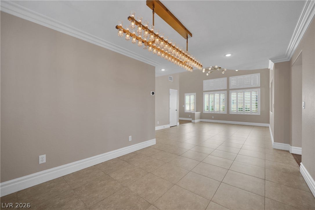 10149 Whitney Falls Court, Las Vegas, NV 89148 An open floorplan flows seamlessly across tile flooring under classic crown molding.
