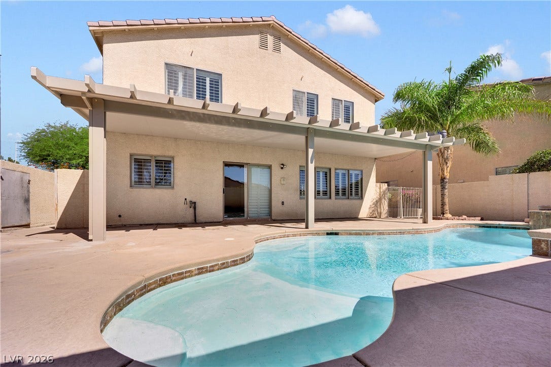 10149 Whitney Falls Court, Las Vegas, NV 89148 A sparkling private pool adjoins a covered patio beneath a tiled roof structure.