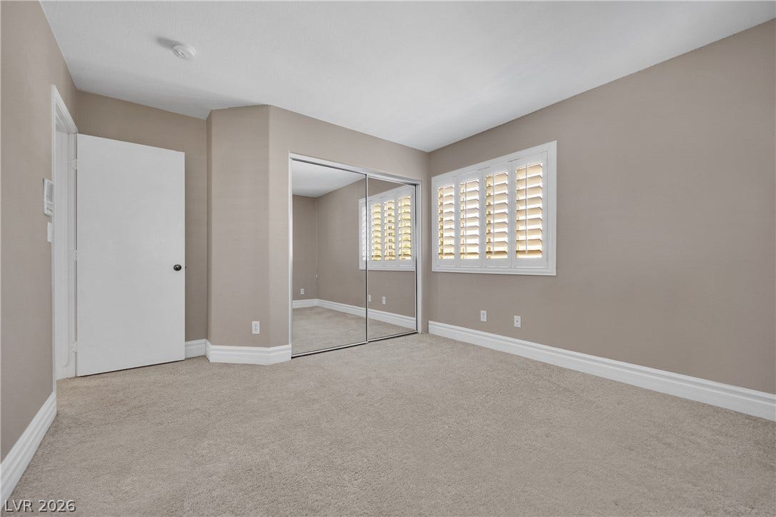 10149 Whitney Falls Court, Las Vegas, NV 89148 Plush carpeting and classic plantation shutters define this versatile secondary bedroom space.