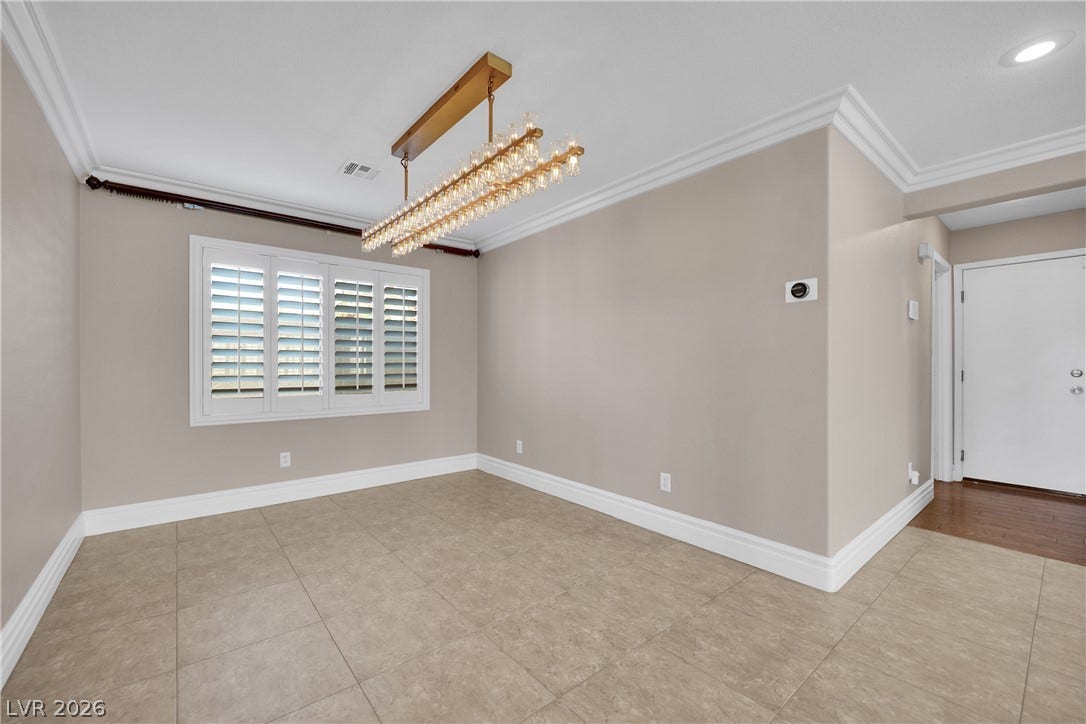 10149 Whitney Falls Court, Las Vegas, NV 89148 Elegant crown molding, classic tile flooring, and integrated lighting define this versatile dining area.