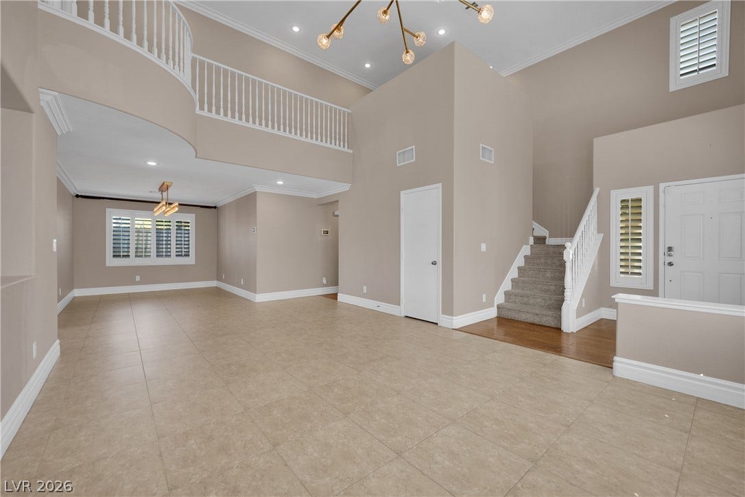 10149 Whitney Falls Court, Las Vegas, NV 89148 High ceilings and an open staircase elevate this airy, tile-floored entryway.
