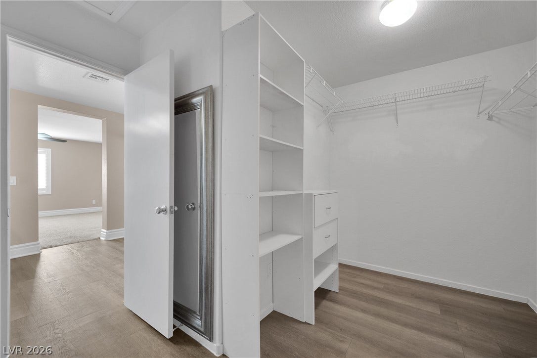 10149 Whitney Falls Court, Las Vegas, NV 89148 Ample built-in shelving and wire racks maximize storage space in this organized walk-in closet.