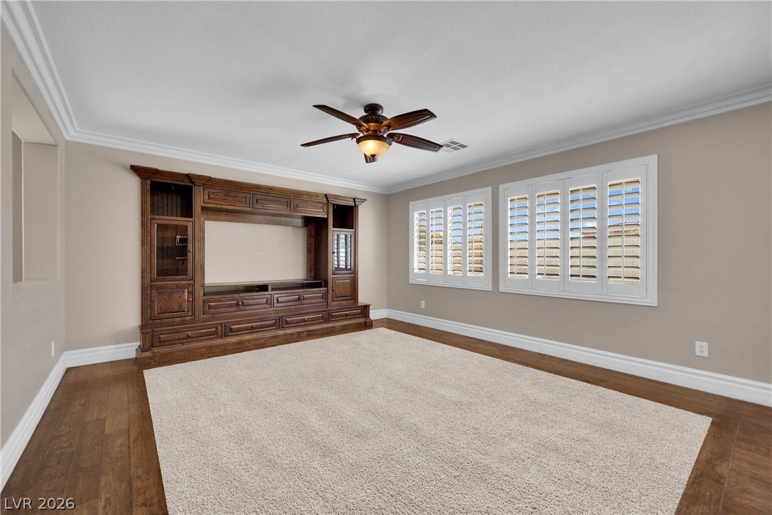 10149 Whitney Falls Court, Las Vegas, NV 89148 Rich wood floors border carpeting in this comfortable room featuring a built-in media center.