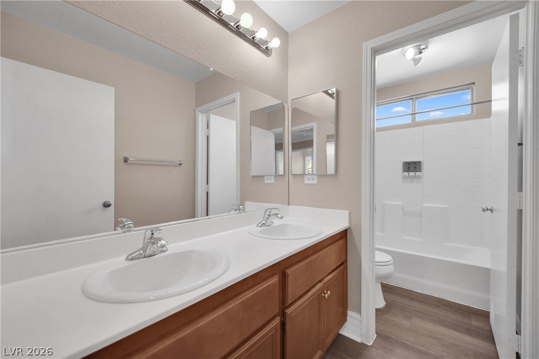10149 Whitney Falls Court, Las Vegas, NV 89148 A spacious double vanity connects seamlessly to an adjacent tub and shower area.