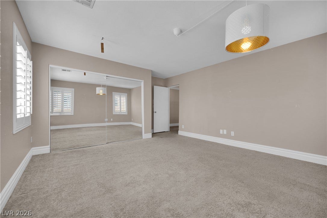 10149 Whitney Falls Court, Las Vegas, NV 89148 An inviting bedroom features plush carpeting, plantation shutters, and a large mirrored closet.