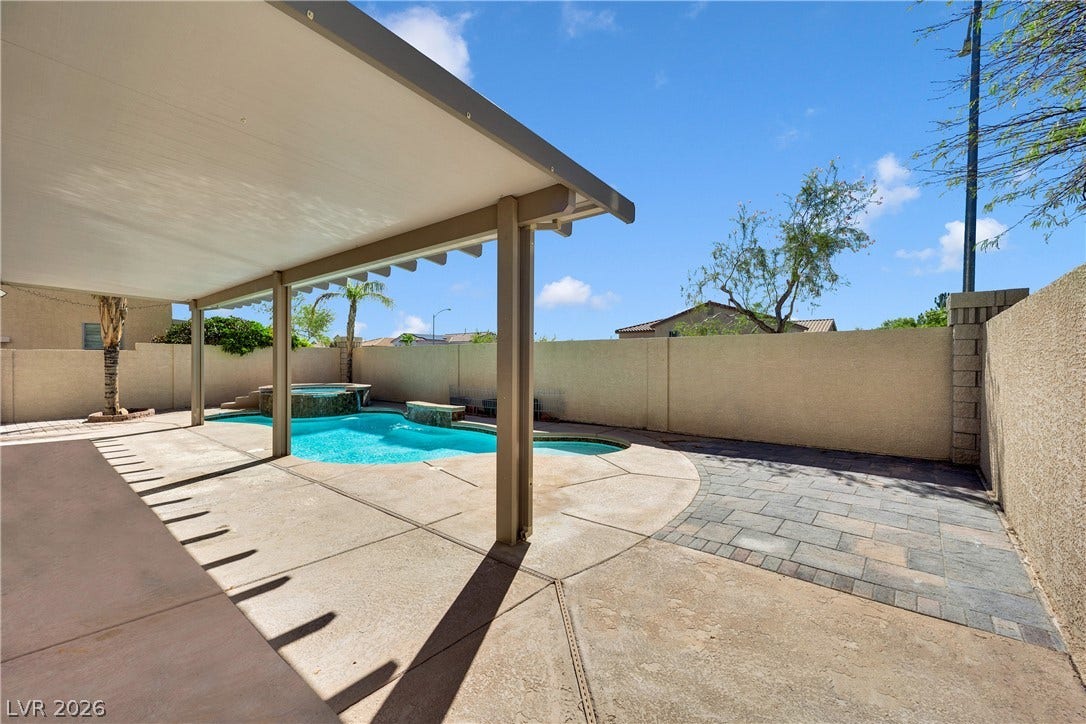 10149 Whitney Falls Court, Las Vegas, NV 89148 An inviting backyard oasis features a covered patio beside a sparkling in-ground swimming pool.
