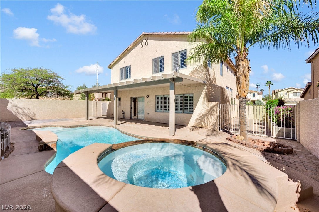 10149 Whitney Falls Court, Las Vegas, NV 89148 A spacious backyard oasis features an inviting swimming pool and an adjacent built-in spa.