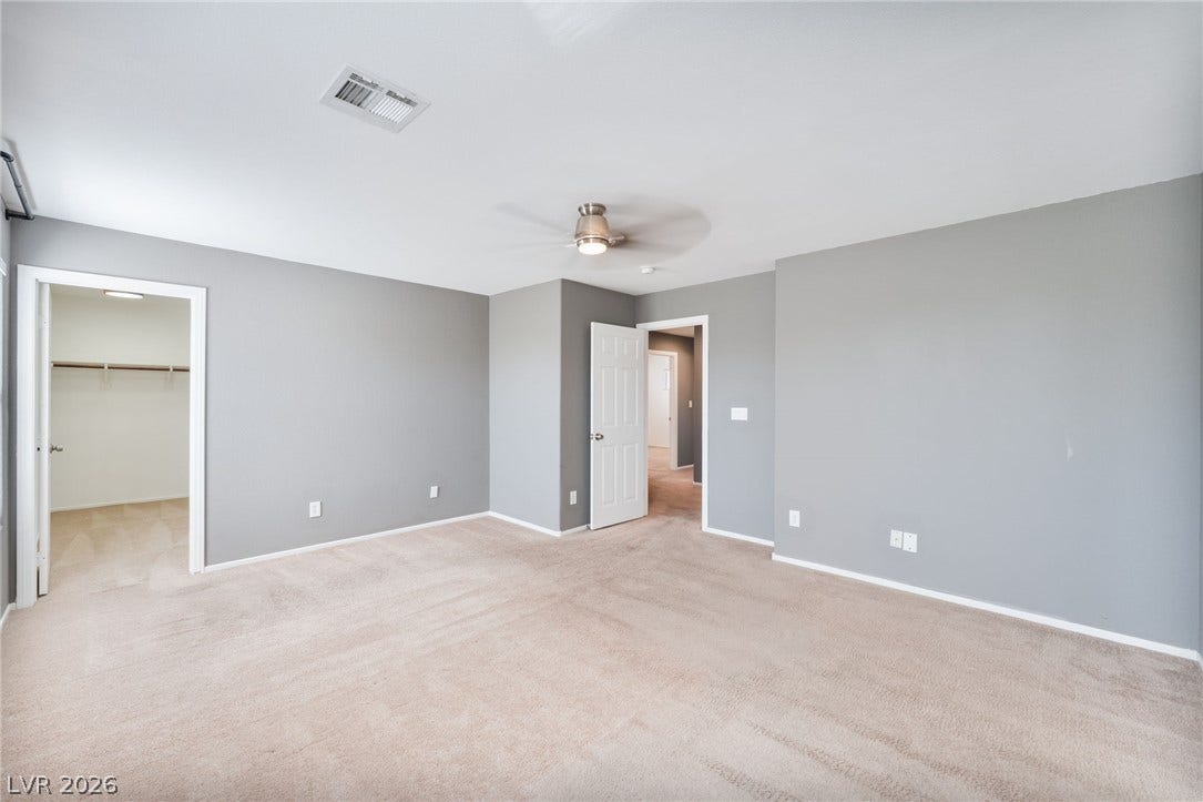 2825 Woodland Park Avenue, North Las Vegas, NV 89086 Soft carpet and clean plaster walls define this versatile interior space.