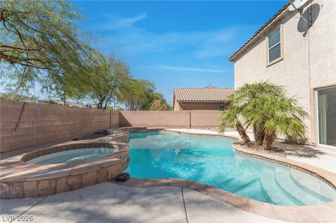 2825 Woodland Park Avenue, North Las Vegas, NV 89086 An inviting private pool and spa highlight the spacious concrete patio area.