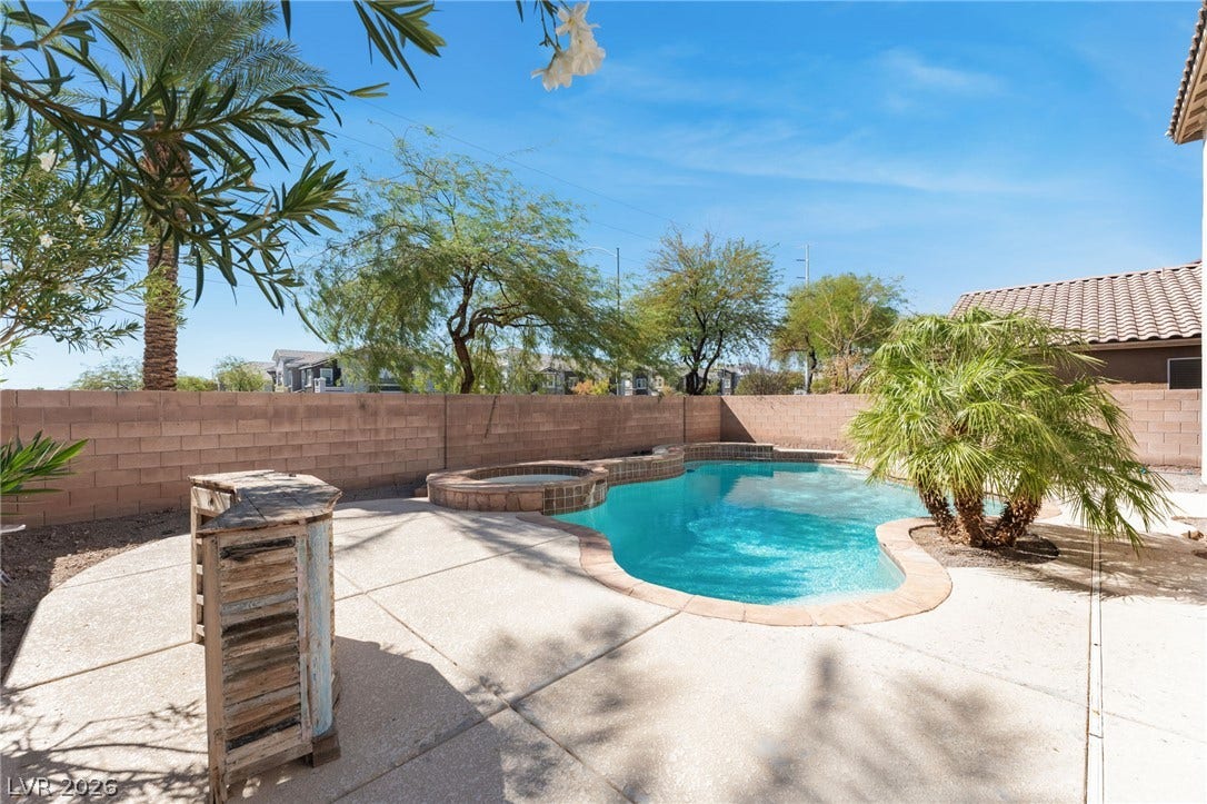 2825 Woodland Park Avenue, North Las Vegas, NV 89086 A sparkling swimming pool highlights this block-walled backyard retreat.