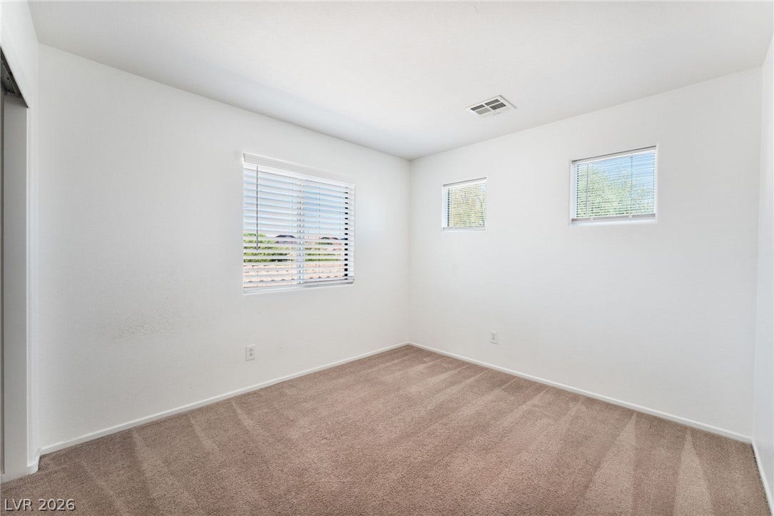 2825 Woodland Park Avenue, North Las Vegas, NV 89086 Plush carpeting and multi-directional windows define this versatile secondary bedroom space.