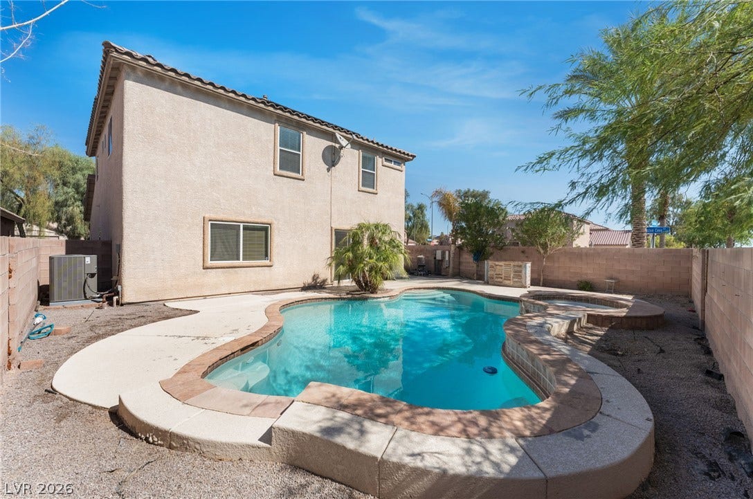 2825 Woodland Park Avenue, North Las Vegas, NV 89086 An inviting private pool anchors the low-maintenance backyard of this two-story stucco home.