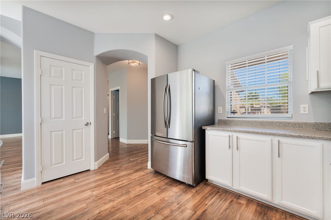 2825 Woodland Park Avenue, North Las Vegas, NV 89086 Rich wood-look flooring and solid-surface counters anchor this functional cooking space.