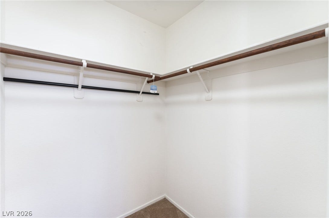 2825 Woodland Park Avenue, North Las Vegas, NV 89086 Ample hanging rods and overhead shelving maximize organization within this walk-in closet.