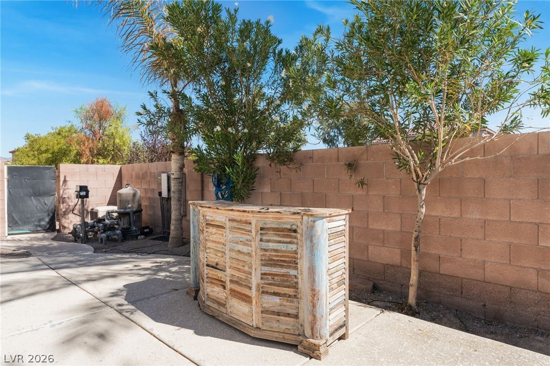 2825 Woodland Park Avenue, North Las Vegas, NV 89086 A spacious concrete patio area is enclosed by a tall block privacy wall.