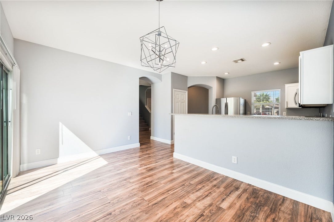 2825 Woodland Park Avenue, North Las Vegas, NV 89086 Gleaming wood-look floors anchor this airy dining space adjacent to the open kitchen area.