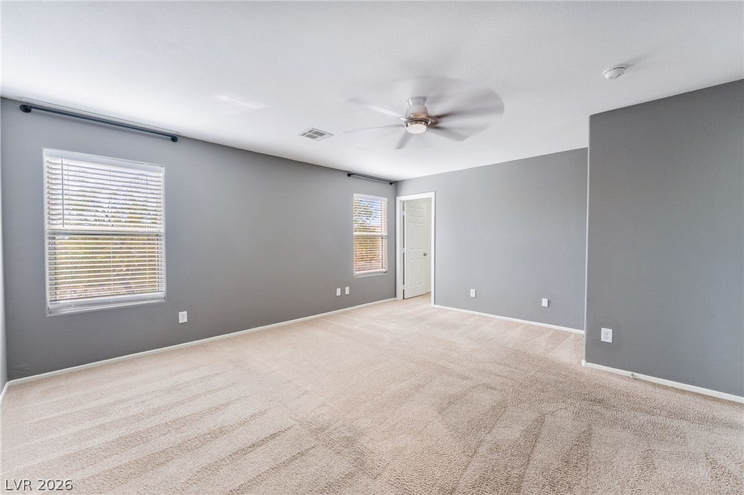 2825 Woodland Park Avenue, North Las Vegas, NV 89086 Plush carpeting underfoot and dual windows define this serene and versatile upstairs bedroom.