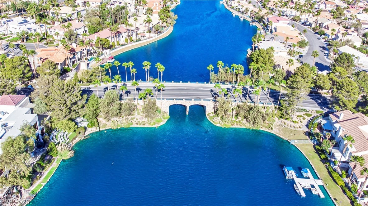Vibrant blue water channels wind through an established residential lakeside community.