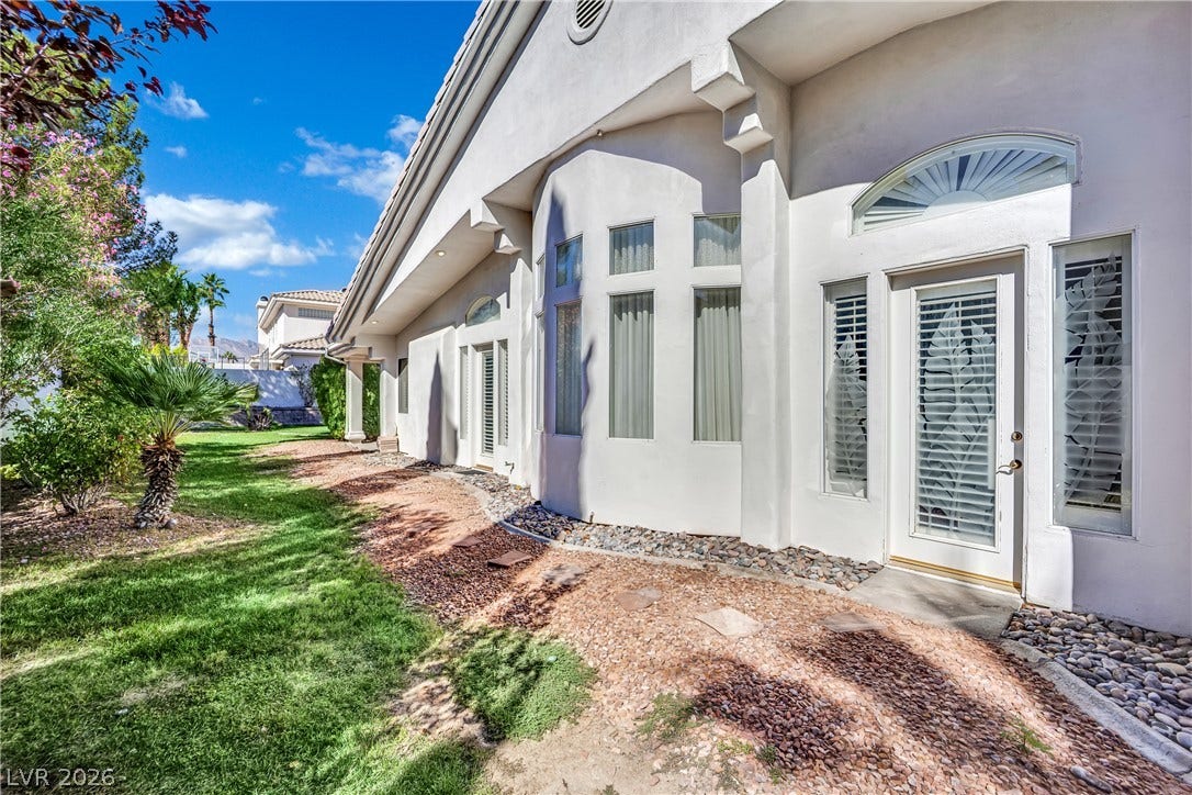 Crisp stucco walls and soaring windows define this elegant residential architecture.