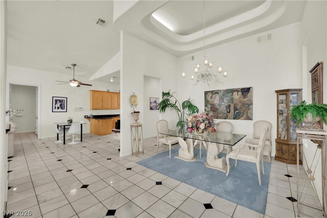 Gleaming tile floors and architectural ceiling details define this elegant dining space.
