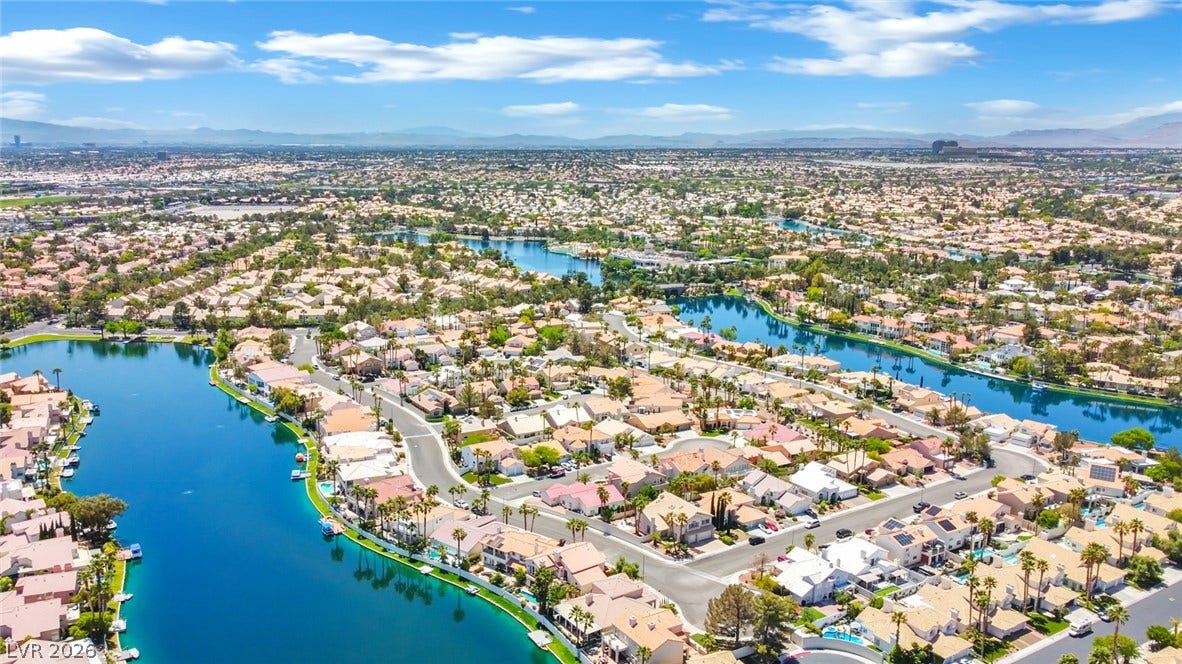An aerial perspective showcases a vibrant waterfront neighborhood surrounded by serene blue lakes.