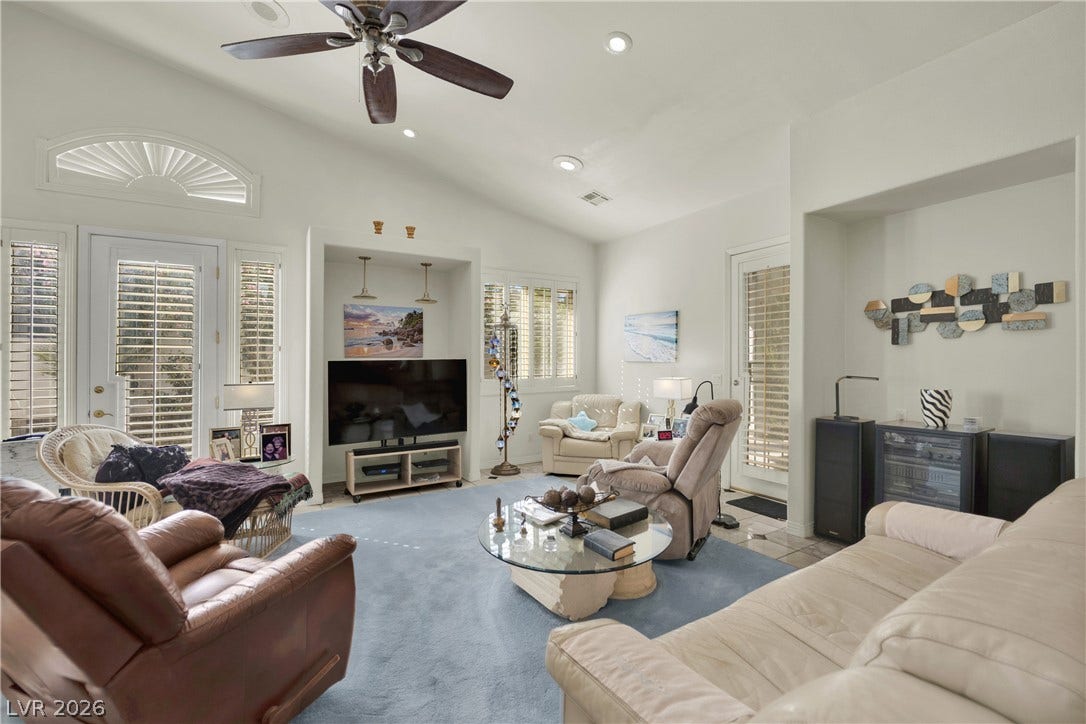 High vaulted ceilings and integrated alcoves elevate this relaxed living space.