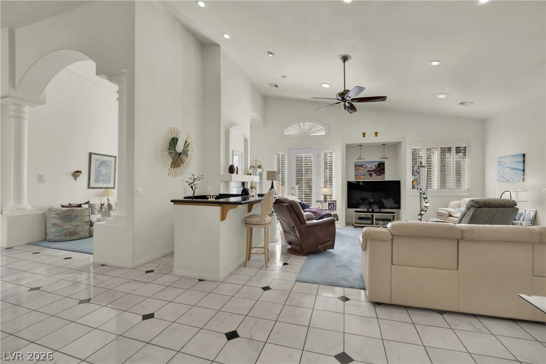 Gleaming tile floors and vaulted ceilings define this airy, open-concept living space.