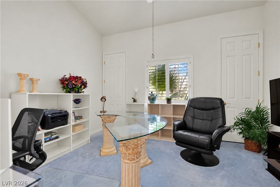 High vaulted ceilings and integrated shelving define this tranquil workspace.
