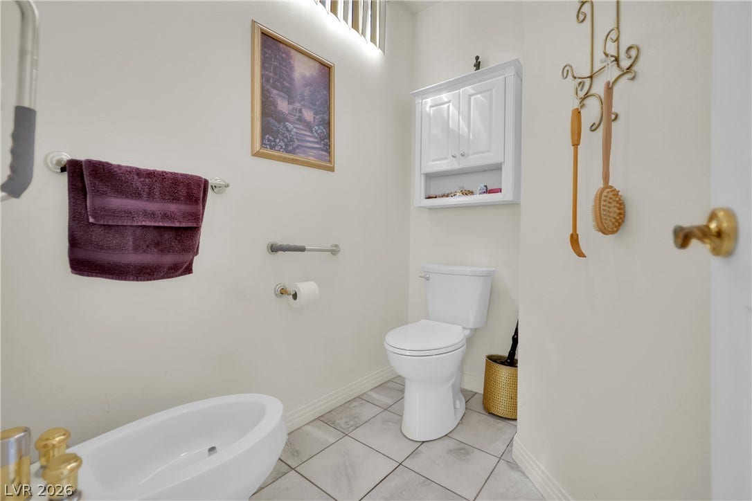 Tiled flooring and neutral walls define this functional bathroom space.