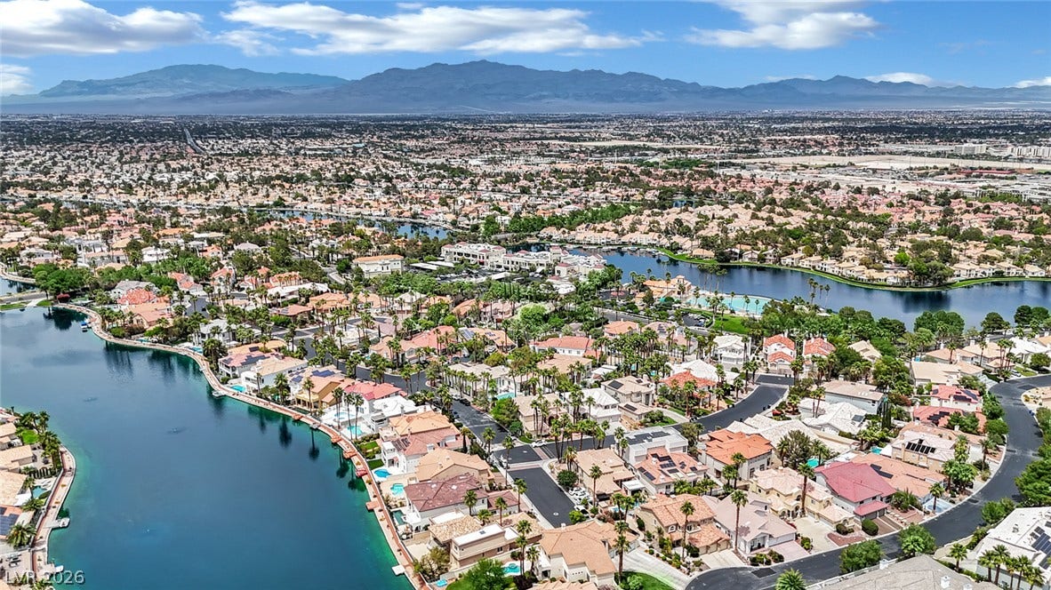 Dramatic mountain ranges frame the sparkling blue waterways of this premier desert community.