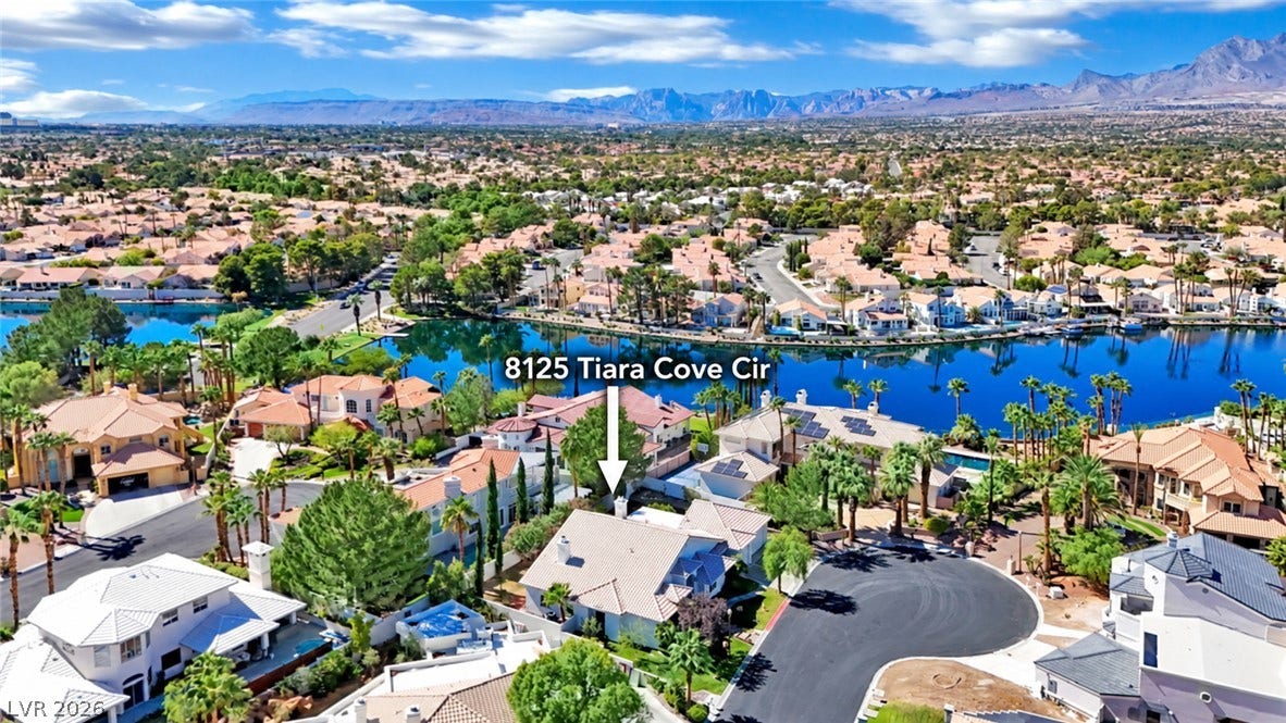 Dramatic mountain vistas and sparkling water views define this exceptional lakeside neighborhood setting.