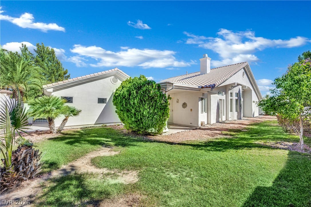 A classic tile roof and manicured green lawn highlight this charming exterior.