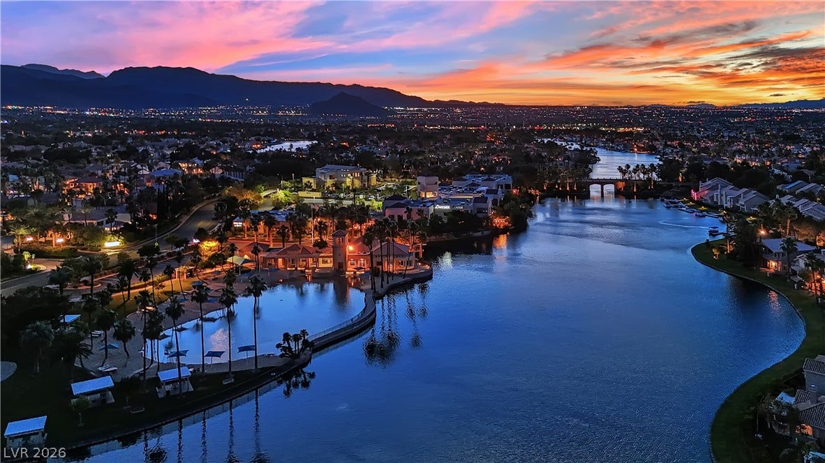 Glistening waters and distant mountain peaks frame this scenic community at twilight.