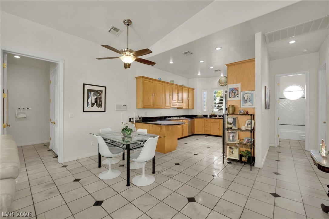 An open layout connects the tiled dining area directly to the kitchen space.