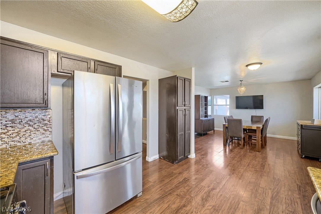 3536 Golden Pedal Street, Las Vegas, NV 89129 Rich wood flooring connects the open-concept kitchen seamlessly to the adjoining dining area.