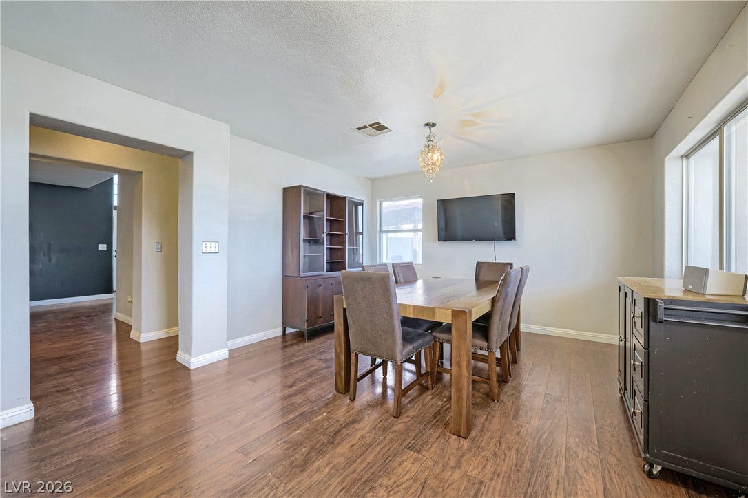 3536 Golden Pedal Street, Las Vegas, NV 89129 Rich wood flooring runs throughout this open dining room featuring high ceilings and detailed molding.