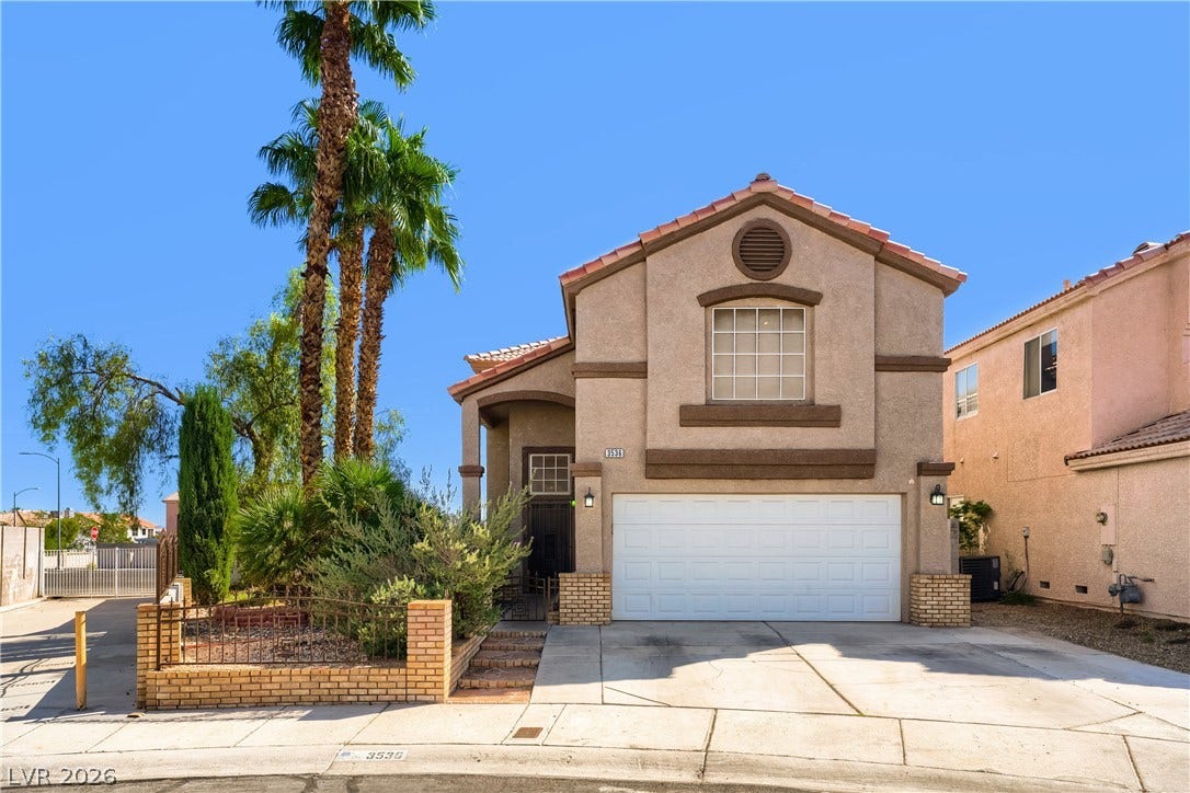 3536 Golden Pedal Street, Las Vegas, NV 89129 Stately palm trees frame a classic stucco exterior complete with an attached two-car garage.