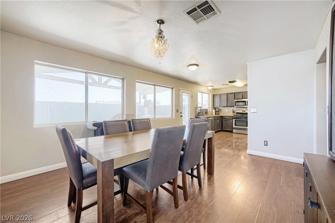 3536 Golden Pedal Street, Las Vegas, NV 89129 Gleaming hardwood floors and abundant window light define this welcoming dining area and kitchen transition.