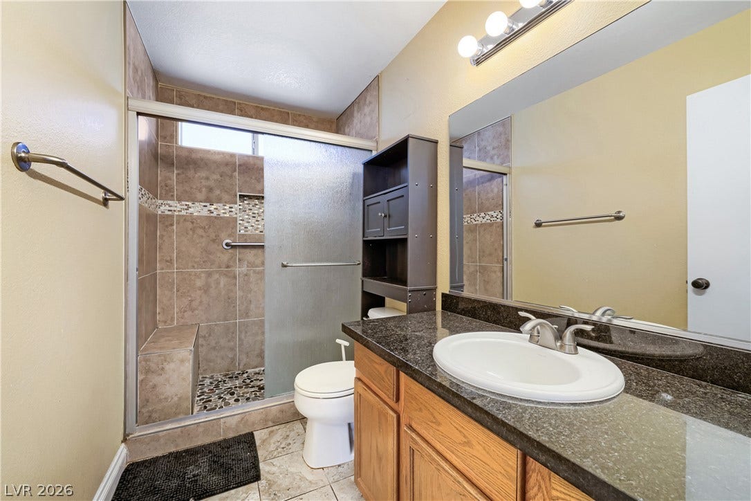 3536 Golden Pedal Street, Las Vegas, NV 89129 Granite counters and a tiled walk-in shower enhance this functional bathroom.