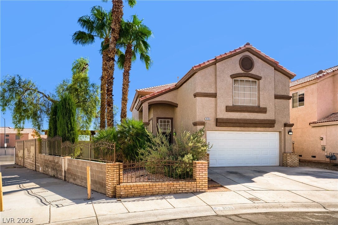 3536 Golden Pedal Street, Las Vegas, NV 89129 Mature palms frame this stucco residence featuring a tile roof and a two-car garage.