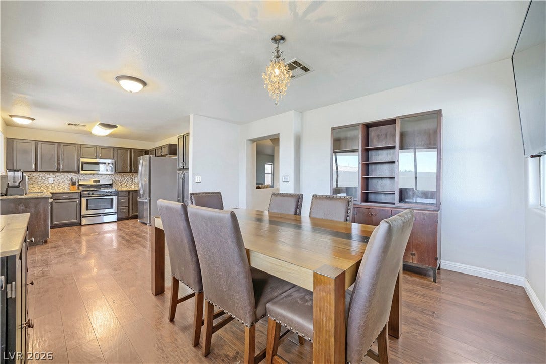 3536 Golden Pedal Street, Las Vegas, NV 89129 Rich wood flooring anchors this inviting dining area opening directly to the kitchen.