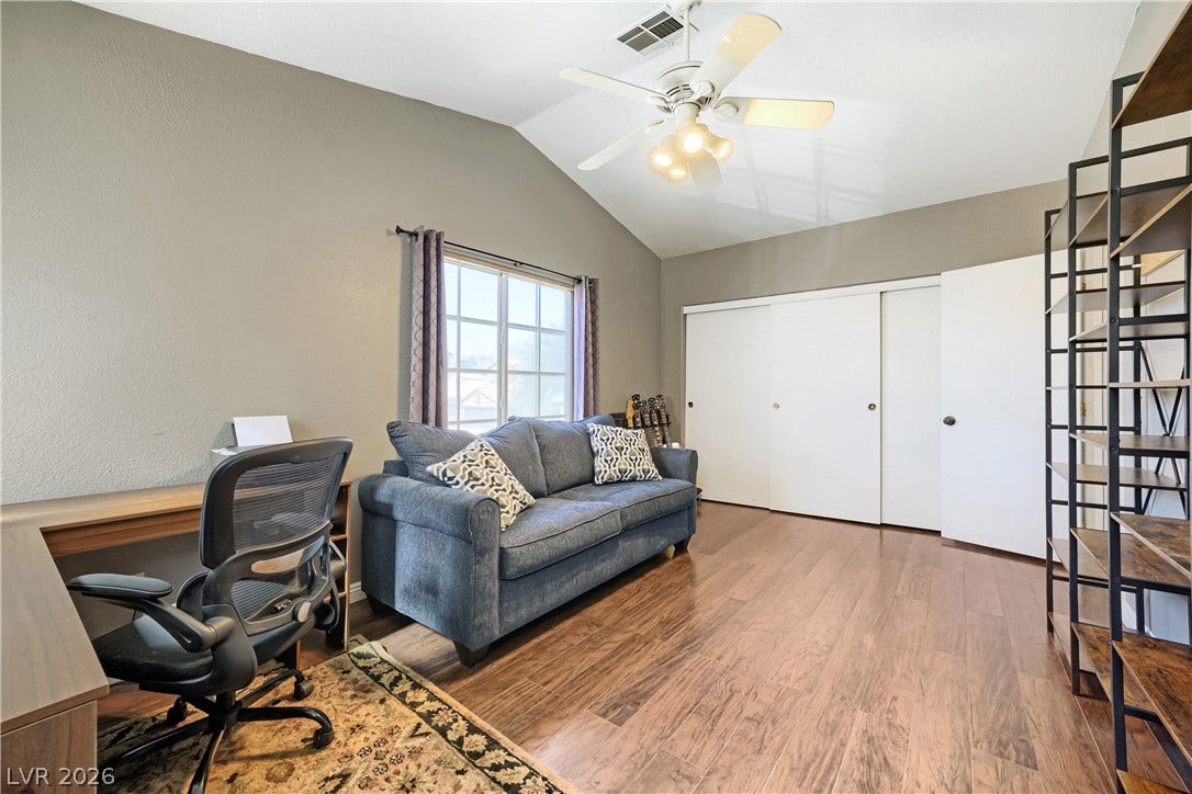 3536 Golden Pedal Street, Las Vegas, NV 89129 A vaulted ceiling and rich wood flooring define this versatile secondary space.